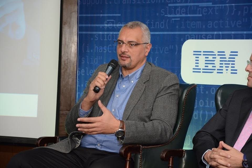 Sherif speaking into microphone during panel discussion